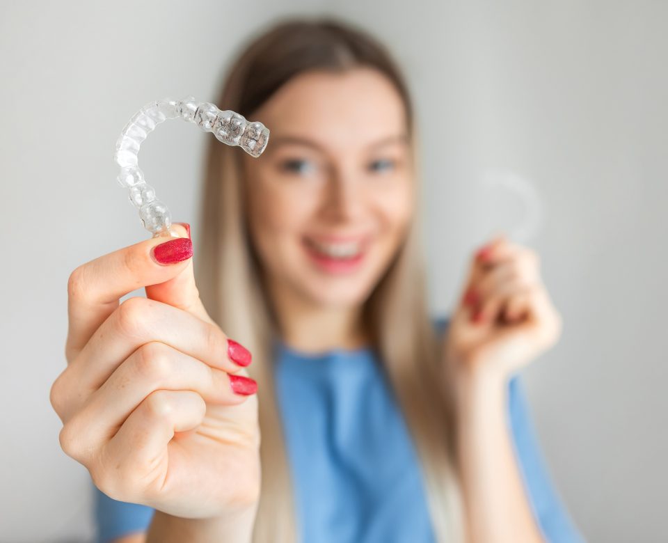 Female Hand Holding Invisalign, The Invisible Braces Aligner At